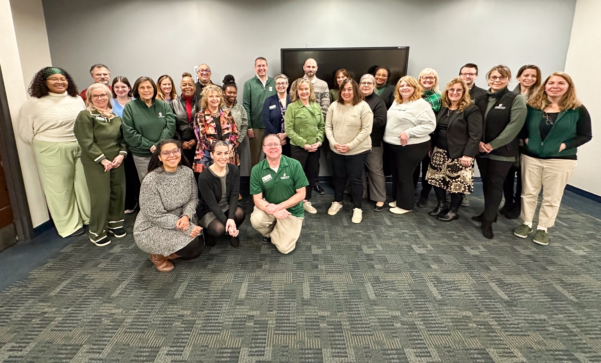 Graduate School staff smiles with Dean Tolone in center of group photo